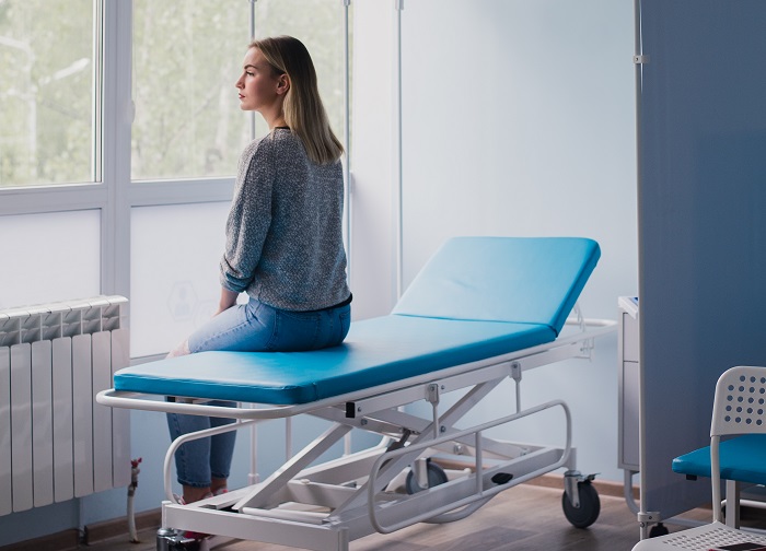 Frau wartet in einem Krankenhaus auf einen Arzt