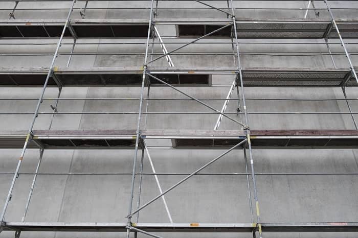 Ein großes Baugerüst steht vor einer großen Häuserfassade