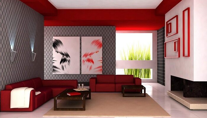 Ein großer Wohnraum, stylisch eingerichtet mit roten Sofas und großem Bild